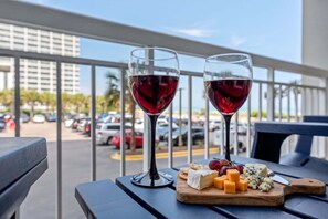 Two wine glasses on a balcony table with a cheese board and grapes. - $150 Free activities - E-gift card when you book- On the ocean | SH105 (Myrtle Beach)