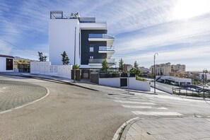 A modern building with a flat roof, multiple balconies, and a paved street in front. - Orizon, Algarrobo Costa (Algarrobo Costa)