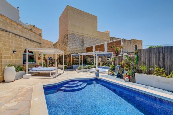 A pool area with a clear blue pool, sun loungers, and a pergola. - Gozo Couple Bungalow No 2 · Pool, Cabana, BBQ Deck (Gozo)