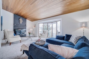 A modern living room with a fireplace, a sofa set, and a dining area. - PATSY - Sleeps 23 | 8 BR 8 BA | 2 SidexSide Homes (Edmonton)
