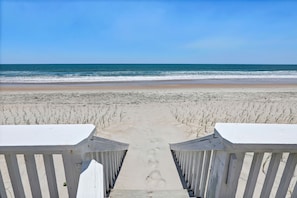 A beach pathway leading to the ocean with wooden railings on both sides. - Oceanfront Luxury Retreat | Private Beach Access | Sunrise & Sunset Views (North Topsail Beach)