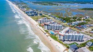 A coastal resort with beachfront hotels, a sandy beach, and a marina. - 1 Bedroom Overlooking Atlantic Ocean and Swimming Pool (North Topsail Beach)