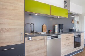 Cafetera o tetera, frigorífico, horno y placa de cocina