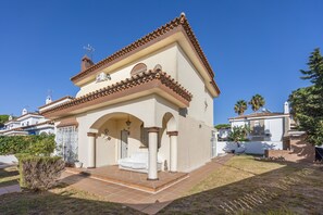 A two-story building with a tiled roof, a small porch with columns, and a clear blue sky. - Holiday Villa with Private Pool in Chiclana de la Frontera (Chiclana de la Frontera)