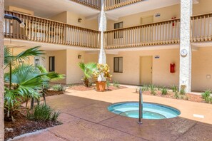 A multi-level building with a central courtyard, a swimming pool, and various potted plants. - Ocean and racquet Club: steps to ocean, pool, tennis and pickleball (saint augustine)
