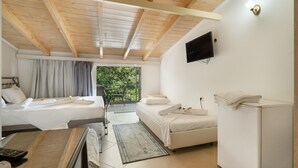 A hotel room with two beds, a TV, a small table, a chair, and a balcony with a view. - Room 'Quadruple  401' with Sea View, Wi-Fi and Air Conditioning (Nikiana)