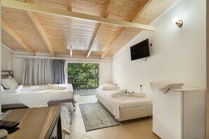 A hotel room with two beds, a TV, a small table, a chair, and a balcony with a view. - Room 'Quadruple  401' with Sea View, Wi-Fi and Air Conditioning (Nikiana)