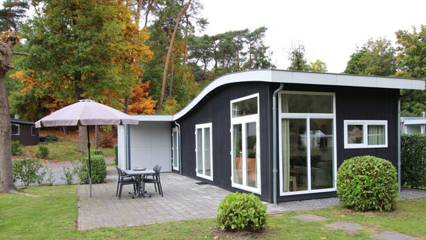 A modern house with a patio, a dining table, and an umbrella. - Holiday Home in Brunssum With Terrace (Brunssum)