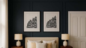A bedroom with a large bed, two bedside tables, a bench, and two framed pictures on the wall. - The Bridge York - Stunning River Front Location (York)