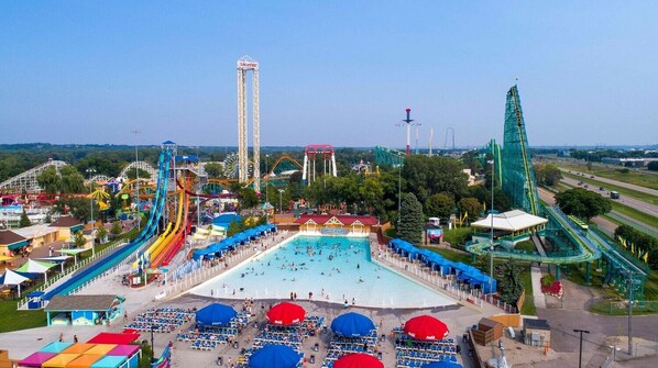 A water park with multiple slides, a large pool, and a tall tower.