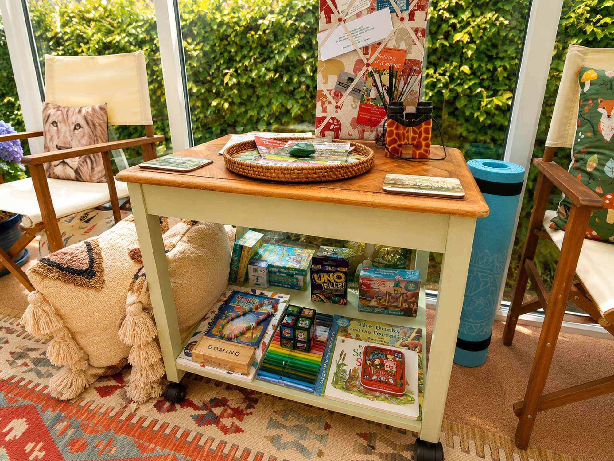 A cozy reading nook with a wooden table, books, and a plush toy.