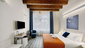 A hotel room with a bed, a desk, a chair, a TV, and a window with curtains. - Room 'Stanza S20' with Wi-Fi and Air Conditioning (Verona)