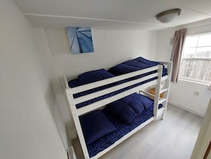 A bunk bed room with a window, a ceiling light, and a wall-mounted artwork. - Holiday Home in Dordrecht With Terrace (Dordrecht)
