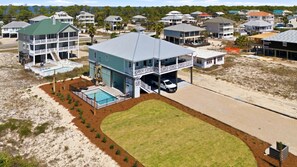 A multi-story building with a pool, a covered garage, and a view of the surrounding neighborhood. - Welcome to Oyster Bay Escape! (St. George Island)