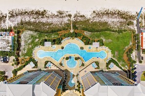 A resort with a central pool, multiple buildings, and a landscaped area. - Relax Above the Emerald Coast | Luxury 2BR Gulf-Front Retreat (Panama City Beach)