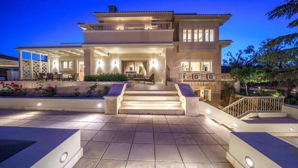 A two-story building with a covered patio area, steps leading to the entrance, and outdoor lighting. - The Villa Rallou Experience (Gazi)