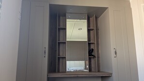 A wardrobe with a mirror, shelves, and a bench. - Seaside Hunstanton Manor Park 2026 Model (Hunstanton)