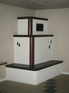 A corner room with a built-in cat tree, a small window, and a tiled floor.
