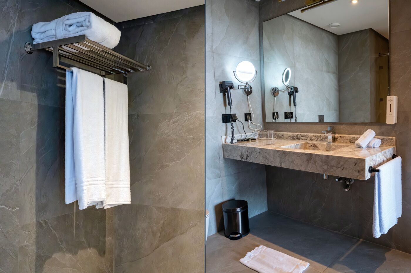 A modern bathroom with a marble vanity, two wall-mounted mirrors, a towel rack, and a trash bin.