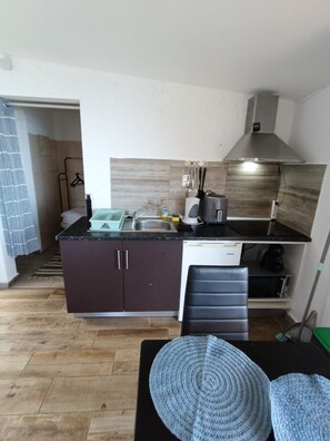 A compact kitchen with a sink, stove, and a dishwasher. - Bungalow 'Private House Ocean View - 1' with Shared Pool, Garden & Wi-Fi (Gaula)