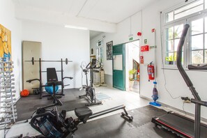 A gym with exercise equipment, a treadmill, and a basketball. - Bungalow 'Private House Ocean View - 1' with Shared Pool, Garden & Wi-Fi (Gaula)