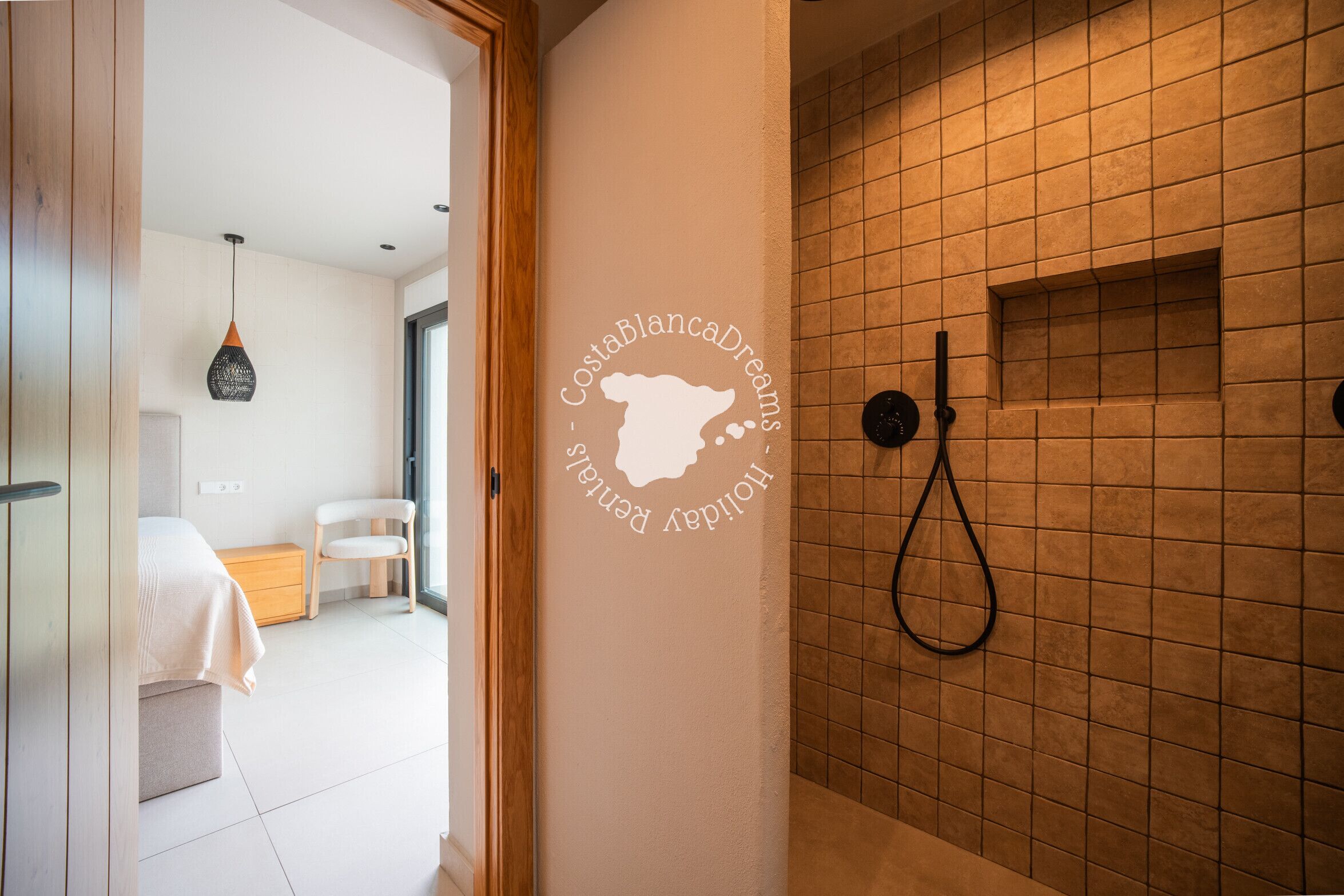 A modern bathroom with a shower, a towel rack, and a wall-mounted towel rack.