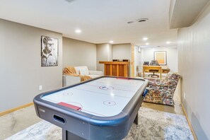 A pool table in a room with a couch, a chair, and a desk with a computer. - Families Welcome! Extended-stay Haven in Medina (Medina)