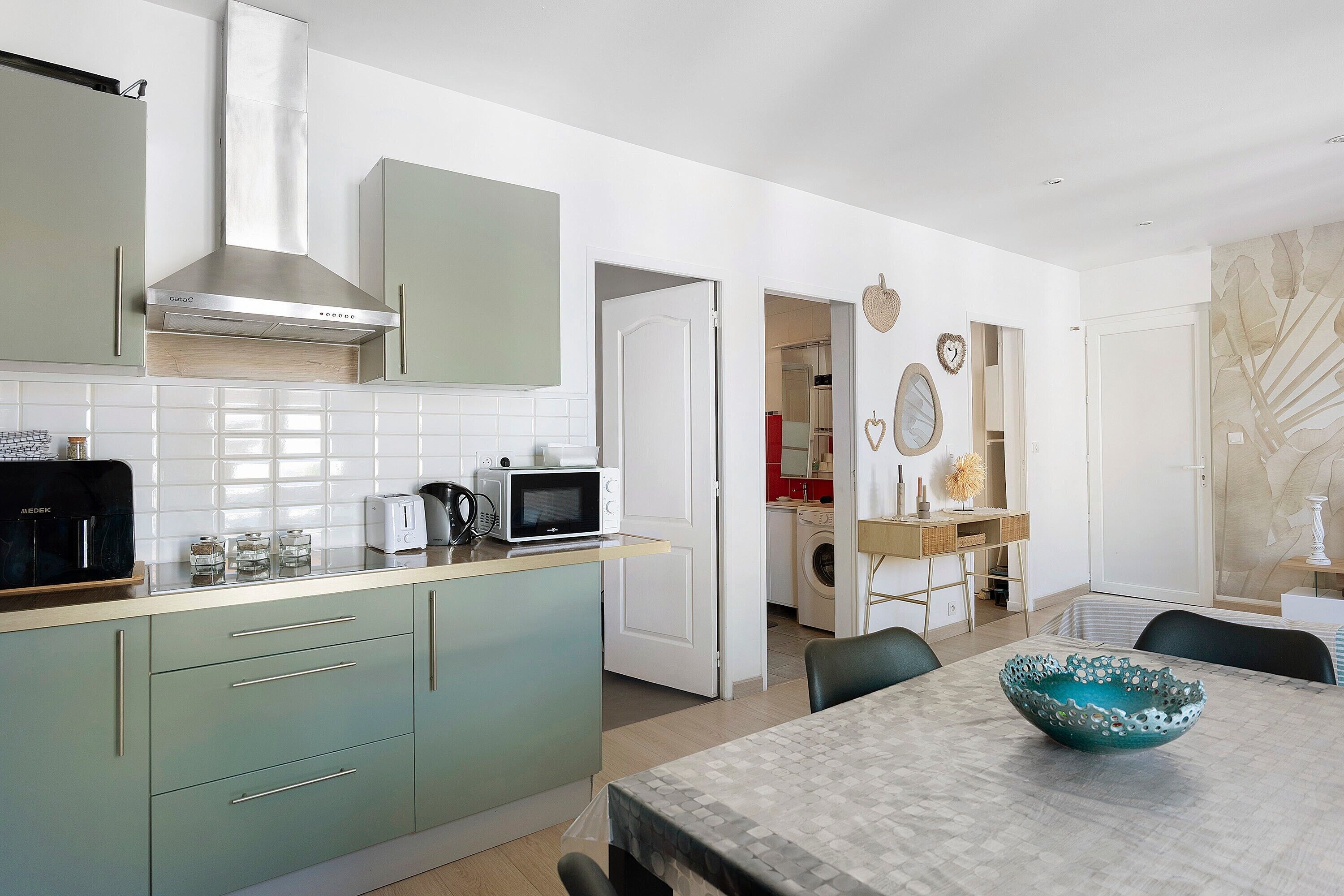 A modern kitchen with a microwave, toaster, and coffee maker on the counter.