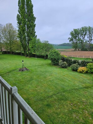 A grassy outdoor area with trees and a fence. - Holiday Home “Le Clos des Argillières” with Private Pool (Le Perrey)