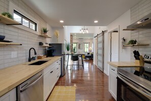 A modern kitchen with wooden countertops, stainless steel appliances, and a central island. - Extended East Knoxville Stay, 2 Mi to Dtwn! (Knoxville)