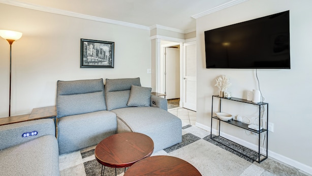 A modern living room with a sectional sofa, a flat-screen TV, a coffee table, and a side table. - Shop, Dine, Explore Dtwn! Punta Gorda Getaway (Punta Gorda)