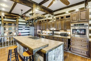 A kitchen with a large island, wooden cabinets, a microwave, and a stainless steel oven. - Shenandoah NP Escape w/ Deck: Hike, Soak + Fish (Stanley)