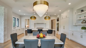 A modern kitchen with white cabinetry, a central island, and pendant lighting. - Luxe Plymouth Group Getaway w/ Office & Foosball (Plymouth)