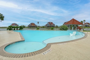 A swimming pool with a 2 ft and 3 ft depth marking, surrounded by a deck with lounge chairs. - Walk to Matagorda Beach! Condo w/ Pool Access (Matagorda)