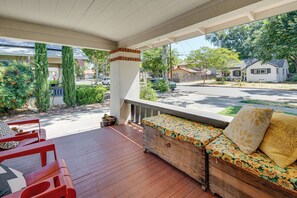 A covered porch with a wooden bench and red chairs, overlooking a residential street. - Pets Welcome! Woodland Family Haven w/ Large Yard (Woodland)