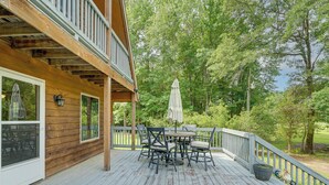 A wooden deck with a table and chairs, surrounded by a railing, overlooking a wooded area. - 10-acre Retreat w/ Hiking! Gateway to Holden Beach (Shallotte)