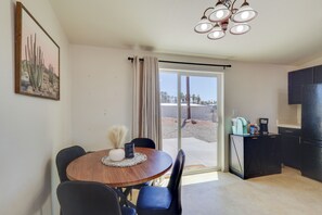 A dining area with a table, chairs, and a view through a sliding door to an outdoor patio. - Off-roading & Boating Base! 4 Mi to Lake Havasu (Lake Havasu City)