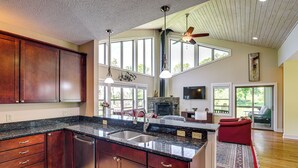 A spacious kitchen with a large island, wooden cabinets, and a built-in dishwasher. - Asheville Mountain Hideaway, 6 Mi to Dtwn (Asheville)
