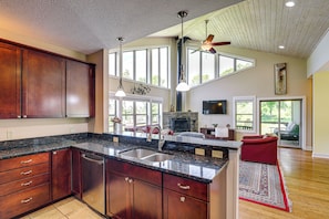 A spacious kitchen with a large island, wooden cabinets, and a built-in dishwasher. - Asheville Mountain Hideaway, 6 Mi to Dtwn (Asheville)