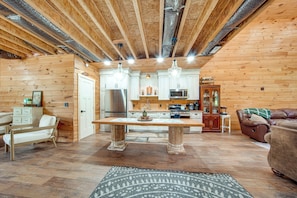 A wooden interior with a kitchen, dining area, and seating. - 3 Mi to Shenango Lake! Dusk-to-dawn Barndominium (Hermitage)