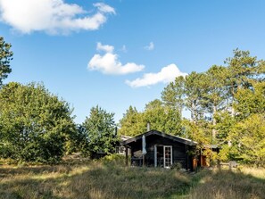 A rustic cabin with a wooden exterior, surrounded by tall trees and a clear sky. - "Sigref" - 4km from the sea by Interhome (Ålbæk)