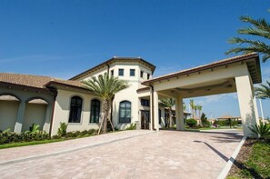 A large building with a covered entrance and a paved driveway. - Modern Championsgate Pool Villa Waterparks! Disney. 616 (Kissimmee)