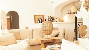 A living room with a sofa, coffee table, and wicker lamps. - Mas de Dard, an Exceptional Estate in Provence, with a heated pool and a padel court (Saintes-Maries-de-la-Mer)