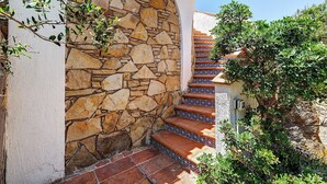 A stone staircase with patterned tiles leading up to a building entrance. - Panoramic Apartment in Villa (Torre dei Corsari)