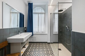 A modern bathroom with a sink, mirror, shower, and patterned floor tiles. - Room 'Stanza S21' with Wi-Fi and Air Conditioning (Verona)