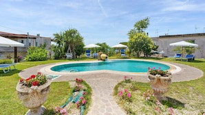 A swimming pool with surrounding lounge chairs and planters. - Holiday Home 'Casa Gio e Angy' with Sea View, Wi-Fi & Air Conditioning (Forio)