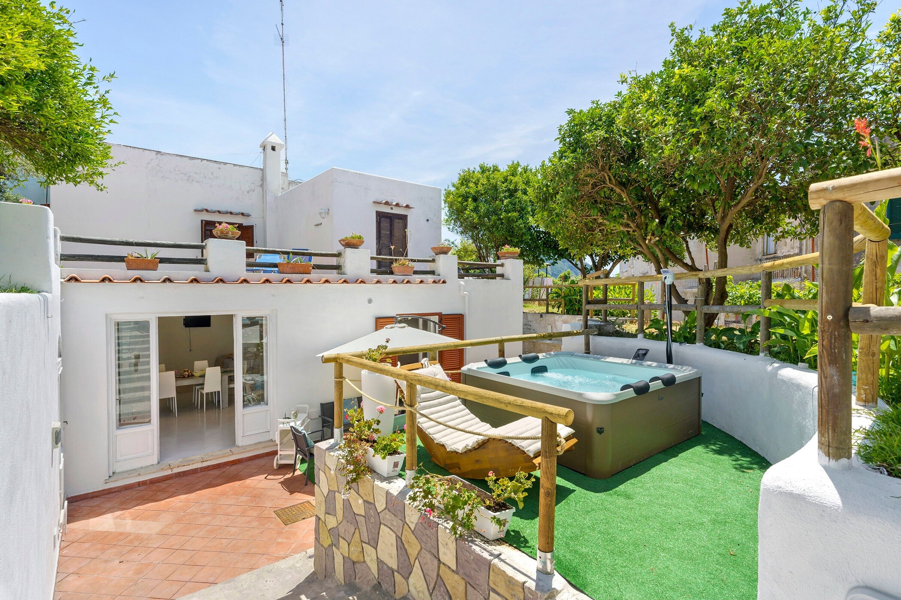 Ein Wohnhaus mit Swimmingpool, überdachter Sitzgelegenheit und Essbereich.