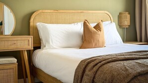 A bed with white linens, a brown throw blanket, and two pillows. - Stunning 2 Bed, 2 Bath Apartment with Parking (Duntocher)