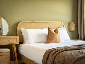 A bed with white linens, a brown throw blanket, and two pillows. - Stunning 2 Bed, 2 Bath Apartment with Parking (Duntocher)