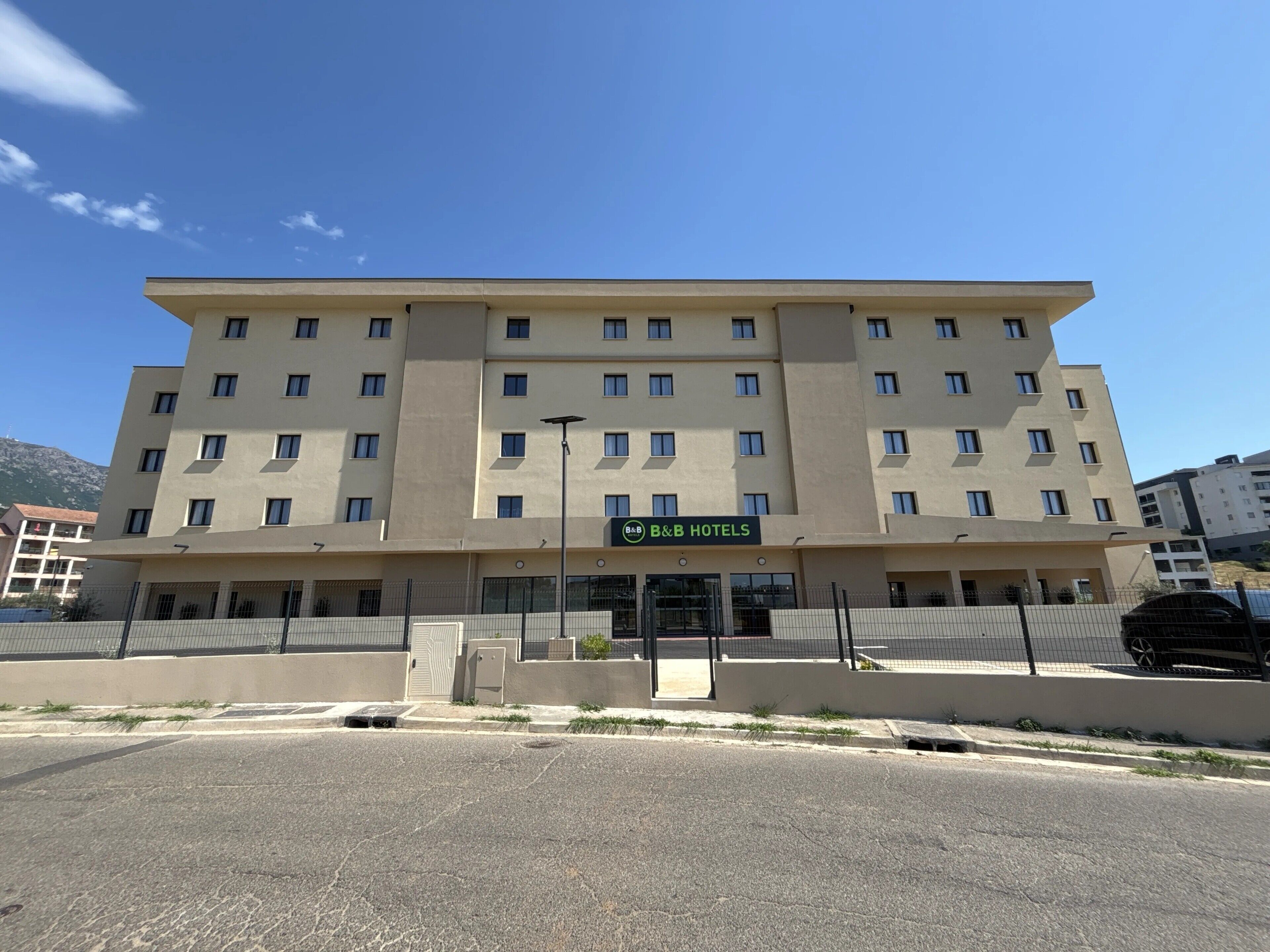 A multi-story hotel with a flat facade, numerous windows, and a sign for B&B HOTELS.